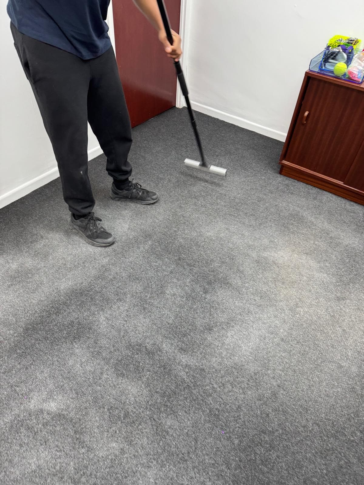 Professional carpet cleaning in London using extraction tool on office carpet to remove dirt and stains